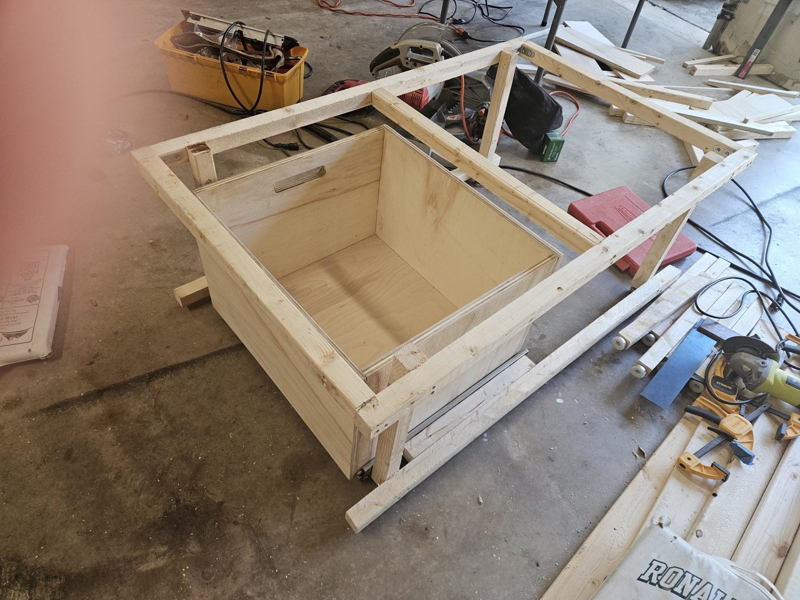 The plywood drawer hung on its slides in the Panel A frame, with the cord slot visible in the far wall