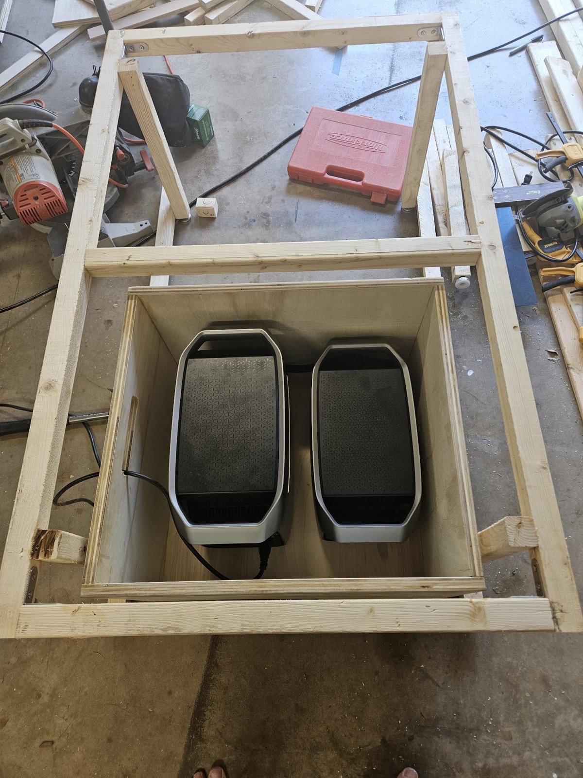 Looking down into the open drawer holding an EcoFlow DELTA 3 Plus and Smart Extra Battery side by side, a cable running out through the cord slot in the drawer wall